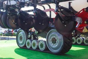 Agriculture equipment concept. Detailed closeup agricultural machinery, big wheels with tires. Outdoor shot photo