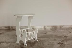 The antique white wooden stand for flowers photo