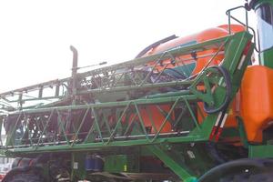 Agriculture equipment concept. Detailed closeup agricultural machinery, big wheels with tires. Outdoor shot photo