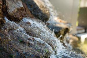 Close up of water splashing on rocks from a waterfall photo