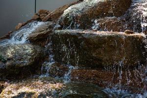 Close up of water splashing on rocks from a waterfall photo