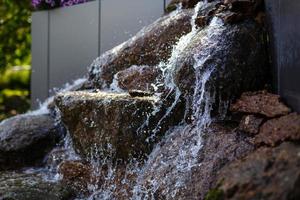 Close up of water splashing on rocks from a waterfall photo