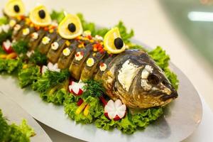 gefilte fish,Gefilte fish on the plate closeup.Delicious stuffed carp with lemon.Fish carp stuffed.Stuffed fish with lettuce leaves. photo