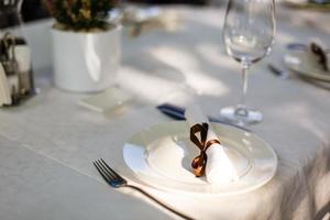 Served table in restaurant with dishes and glasses photo
