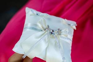 wedding rings on a pillow photo