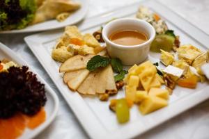 A plate of cheese and crackers on a party buffet table photo