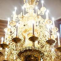 Big bronze chandelier in cathedral christian church photo