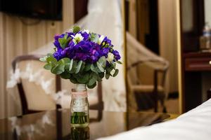 Image of a beautiful floral bouquet on wood table on the background of a veil photo