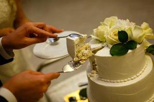 White wedding cake with real roses decorations photo