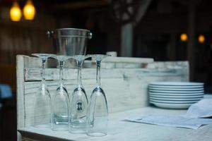 Series of inverted empty wine glasses arranged in several rows. photo