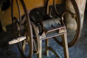 very old spinning wheel and a spindle photo