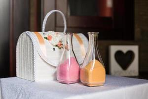 Decorative glass bottles with colored cereal, colored sand inside photo