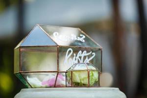 stylish decorated glass box for wedding greetings and cards and gifts at the reception in a restaurant photo