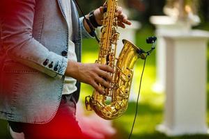 World Jazz festival. Saxophone, music instrument played by saxophonist player musician in fest. photo