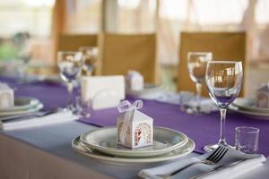 Beautiful flowers, candles and bonbonniere on table in wedding day.Blue color decoration tablecloth photo