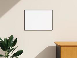 Frame mockup hanging on the wall in minimalist interior room with plant photo