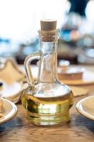 composición con aceite de oliva y aceitunas sobre fondo de madera, de cerca foto