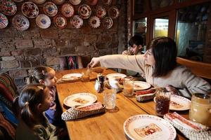 Family having a meal together in authentic ukrainian restaurant. photo