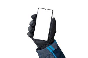 Hand with a winter glove shows a mobile phone. Isolated background and display for mockup, app presentation and winter environment photo