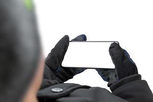 Man holding a mobile phone in a horizontal position. Isolated display and background. Concept intended for presentation of apps, use of mobile maps, playing games on mobile platforms photo