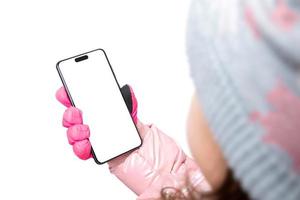 Phone in a gloved hand of a girl, child. Isolated background for app promotion. View over the shoulder photo