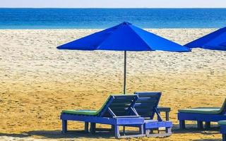 Palms parasols sun loungers beach resort Zicatela Puerto Escondido Mexico. photo