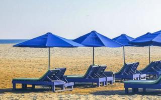 Palms parasols sun loungers beach resort Zicatela Puerto Escondido Mexico. photo