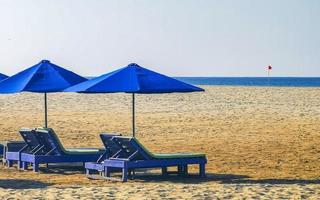 Palms parasols sun loungers beach resort Zicatela Puerto Escondido Mexico. photo