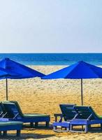 Palms parasols sun loungers beach resort Zicatela Puerto Escondido Mexico. photo