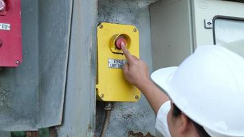 Portrait of professional Asian electrical engineer turning on the switches. video