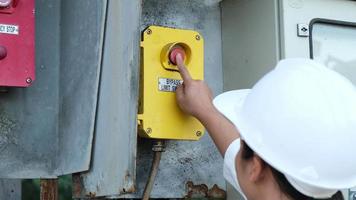 Portrait of professional Asian electrical engineer turning on the switches. video