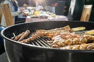 Cooking food on the barbecue, outdoor. Delicious meat on sticks and cheese on the grill, in the courtyard of the house. in the spring. photo