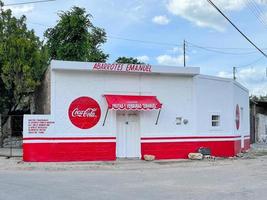 Izamal Mexico  May 23 2021   Colorful exterior of a grocery store in the white and red colors of CocaCola photo