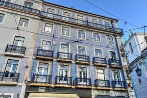 Lisbon windows with typical portuguese tiles on the wall photo