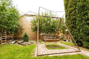 wooden swing in the yard photo