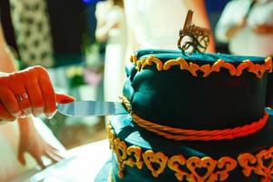 Wedding blue cake with edible gold leaf photo