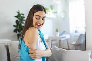 Adhesive bandage on arm after injection vaccine or medicine,ADHESIVE BANDAGES PLASTER - Medical Equipment,Soft focus Adhesive bandage on a female brachium after covid-19 vaccination,Thump up, photo