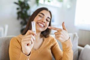 Close-up shot of woman's hand holding a negative test device. Happy young woman showing her negative Coronavirus - Covid-19 rapid test. Focus is on the test.Coronavirus photo