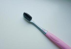 A gray-pink toothbrush lies on the surface photo