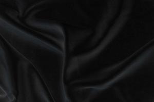 Smooth elegant black silk fabric or satin luxury cloth texture for abstract background photo