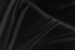 Smooth elegant black silk fabric or satin luxury cloth texture for abstract background photo