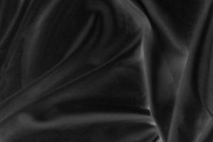 Smooth elegant black silk fabric or satin luxury cloth texture for abstract background photo