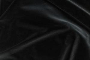 Smooth elegant black silk fabric or satin luxury cloth texture for abstract background photo