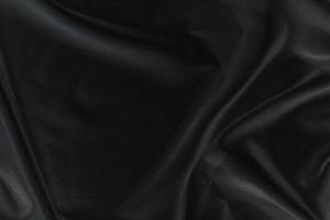 Smooth elegant black silk fabric or satin luxury cloth texture for abstract background photo
