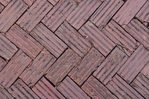 walkway is paved with brown bricks. photo