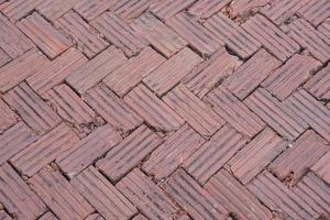 walkway is paved with brown bricks. photo