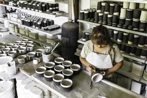 The master ceramist works in her studio. photo