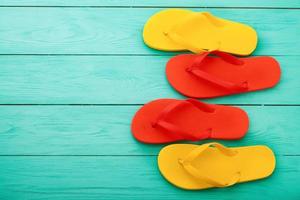 flip flops on blue wooden background with copy space. Top view. Mock up. Summer shoes sandals. Slippers photo