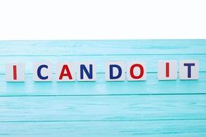 Words of motivation. I can do it. Blue wooden background, selective focus and copy space. Isolated on white photo