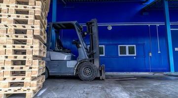 The loader unloads pallets at the factory and warehouse photo